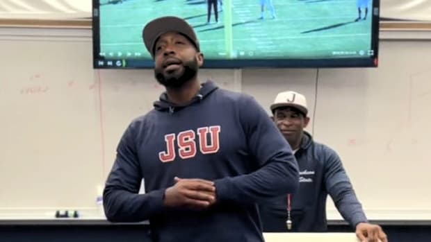 T.C. Taylor standing in front of Deion Sanders